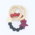 Detail view of silicone beads and wooden rings on a colorful baby teether rattle - Purple