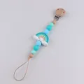 Handmade silicone pacifier clip with rainbow charm and blue beads for baby teething - Mint Green