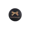 Round black leather handmade label with golden bow pattern and handmade lettering - Bow Style / Black