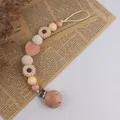 Sujeta chupetes bohemio con cuentas de madera de haya, girasol y detalles de ganchillo - Beige