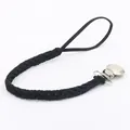 Detail of black braided leather pacifier clip with silver metal clamp and ring - Black