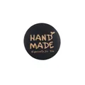 Round black wooden tag featuring yellow Hand Made and Especially For You engraved text - Black
