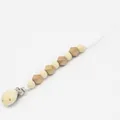 Detail of wooden pacifier clip featuring natural round beads and golden hexagonal beads - Gold