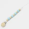 Detail of wooden pacifier clip with light blue silicone beads and secure white cord - Blue