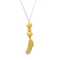 Close-up of yellow silicone feather pendant and geometric beads on a soft teething necklace - Yellow