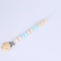 Natural wood and light blue silicone bead baby pacifier clip with a round wooden clamp - Blue