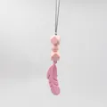 Detail of pink silicone feather teething necklace with hexagonal sensory beads for baby - Pink