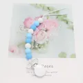 Blue and white silicone pacifier clip with safety beads and secure snap closure - Blue