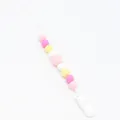 Detailed view of colorful silicone beads pacifier clip with white plastic safety buckle - Pink