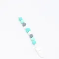 Detail of silicone baby pacifier clip with mint green and grey hexagonal beads - Teal