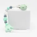 Detail of silicone pacifier clip with mint green crown pendant and marble beads - Green