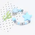 Detail of baby pacifier clip with blue silicone stars, baby beads and wooden metal clip - Blue