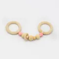 Detail of baby beech wood rattle with pink silicone beads and smooth natural timber rings - Double Ring Style (Circle)