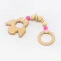 Close-up of baby teether with beech wood rocket, smooth wooden rings and pink silicone beads - Rocket Style (Cactus)