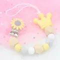 Sujetachupetes de silicona con girasol amarillo, corona y cuentas de madera - Amarillo