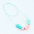 Detail of macaron-colored silicone teething beads with safety breakaway clasp for infants - Lake Blue