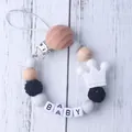 Detail of silicone pacifier clip with wood beads and white crown charm for baby - Black