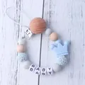 Baby silicone pacifier clip with blue crown and wooden beads on white wood background - Light Blue