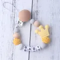 Close-up of silicone pacifier clip with wooden beads and yellow crown decoration - Yellow