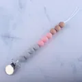 Detail of baby pacifier clip with marble grey, pink silicone beads and beech wood beads - Pink
