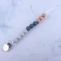 Close-up of silicone beads and beech wood clip on baby dummy chain with marble pattern - Gray