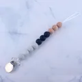 Detail of baby pacifier clip with silicone beads and wooden beads on marble background - Black