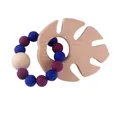 Macro detail of baby teething ring with wooden monstera leaf and silicone beads - Sapphire Blue