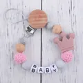 Detail of pink silicone crown pacifier clip with wood beads and letters on wood floor - Light Bean Paste (New)
