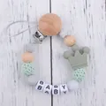 Detailed view of silicone pacifier clip with wood beads and green crown charm - Sage Green (New)