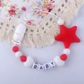 Detailed close-up of a red and white silicone pacifier clip with star and BABY letter beads - Red