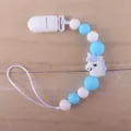Detail of baby silicone pacifier clip with blue beads and white unicorn pendant - Blue Unicorn