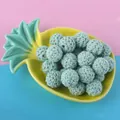 Macro detail of 16mm mint green hand-crocheted wooden beads for DIY jewelry making - Light Green