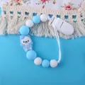 Blue and white silicone pacifier clip with a cartoon sailor bear and plastic clip - Blue