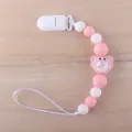 Detailed close-up of pink and white silicone pacifier clip with small elephant bead - Pink Elephant