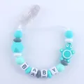 Detalle del sujetachupete de silicona con cuentas de letras BABY y tortuga - Azul lago