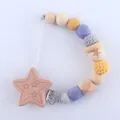 Detail of wooden star clip and silicone teething beads in yellow and purple hues - Star Style