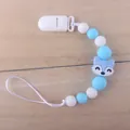 Close-up of baby silicone pacifier clip with blue fox bead and white plastic fastener - Blue Fox