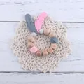 Schnullerkette aus Buchenholz und Silikon mit Federanhängern und hölzernen Buchstabenperlen - Rosa Beißring