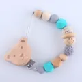 Silicone pacifier clip with wooden bear clip, blue beads, and crochet details for infants - Bear Head Style