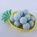 Close-up of 16mm light blue hand-crocheted beads for DIY jewelry on a yellow tray - Light Blue