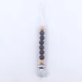 Detail of baby silicone pacifier clip with wood beads and metal safety buckle fastener - Coffee