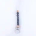 Close-up of baby pacifier clip with grey silicone beads and natural wooden accents - Black
