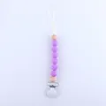 Detail of baby pacifier clip with purple silicone beads and natural wooden accents - Deep purple