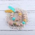 Silikon- und Buchenholz-Schnullerkette mit Makronenperlen, Glocken und BABY-Holzblöcken - Seeblaues Set