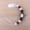 Baby silicone pacifier clip with black and white beads and a cute penguin silicone charm - Penguin Black