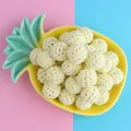 16mm cream crochet cotton beads in pineapple ceramic dish on pink and blue background - Light Yellow