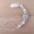 Silicone pacifier clip with grey fox beads and plastic clip on a wooden background - Fox Light Gray