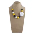 Silicone nursing necklace with yellow, black, white beads and flower pendant - Necklace / Yellow