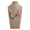 Pink rose silicone teething necklace with colorful beads on a display bust - Necklace / Multicolor