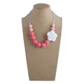 Pink silicone rose teething necklace with round beads for babies on display - Necklace / Rose Red